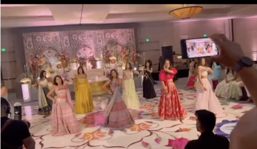 Family group dance at a South Asian wedding celebration